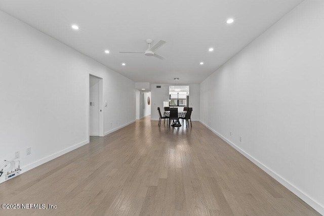 interior space featuring baseboards, recessed lighting, ceiling fan, and light wood-style flooring