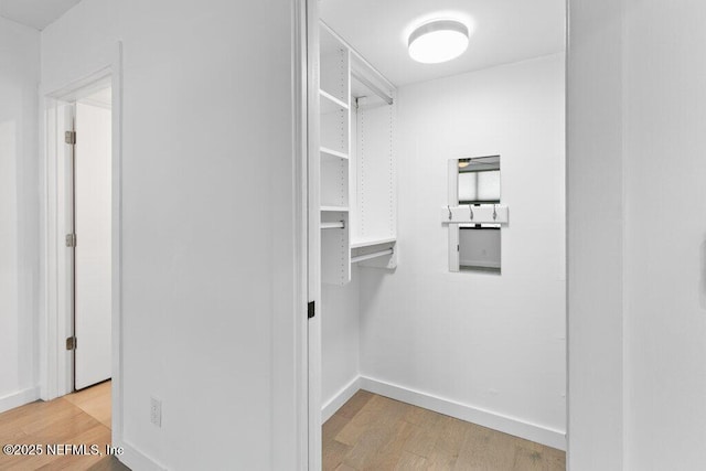 spacious closet with wood finished floors