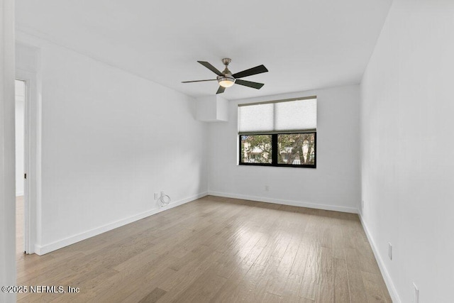 empty room featuring baseboards, a ceiling fan, and wood finished floors