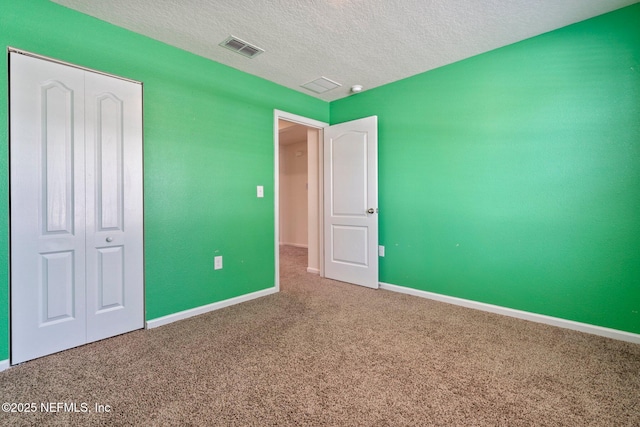 4402 Warm Springs Way, Middleburg, FL 32068 - unfurnished bedroom with carpet floors, a closet, a textured ceiling, and baseboards