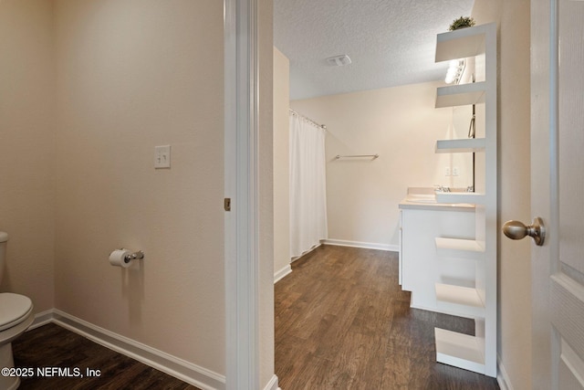 4402 Warm Springs Way, Middleburg, FL 32068 - bathroom featuring toilet, wood finished floors, vanity, a textured ceiling, and baseboards