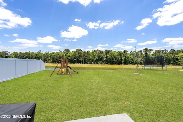 4402 Warm Springs Way, Middleburg, FL 32068 - view of yard with a trampoline and view of wooded area