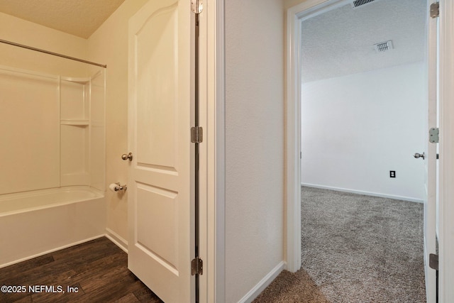 4402 Warm Springs Way, Middleburg, FL 32068 - corridor with dark colored carpet, baseboards, and a textured ceiling