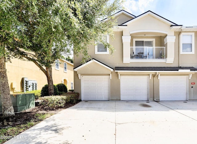 9421 Osprey Branch Trl Unit 4, Jacksonville, FL 32257 - view of front facade featuring stucco siding, driveway, a balcony, and an attached garage