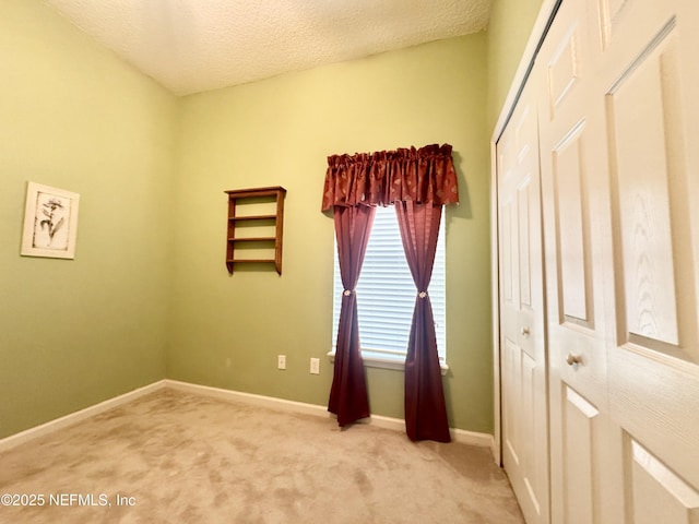 9421 Osprey Branch Trl Unit 4, Jacksonville, FL 32257 - unfurnished bedroom featuring a textured ceiling, a closet, baseboards, and light carpet