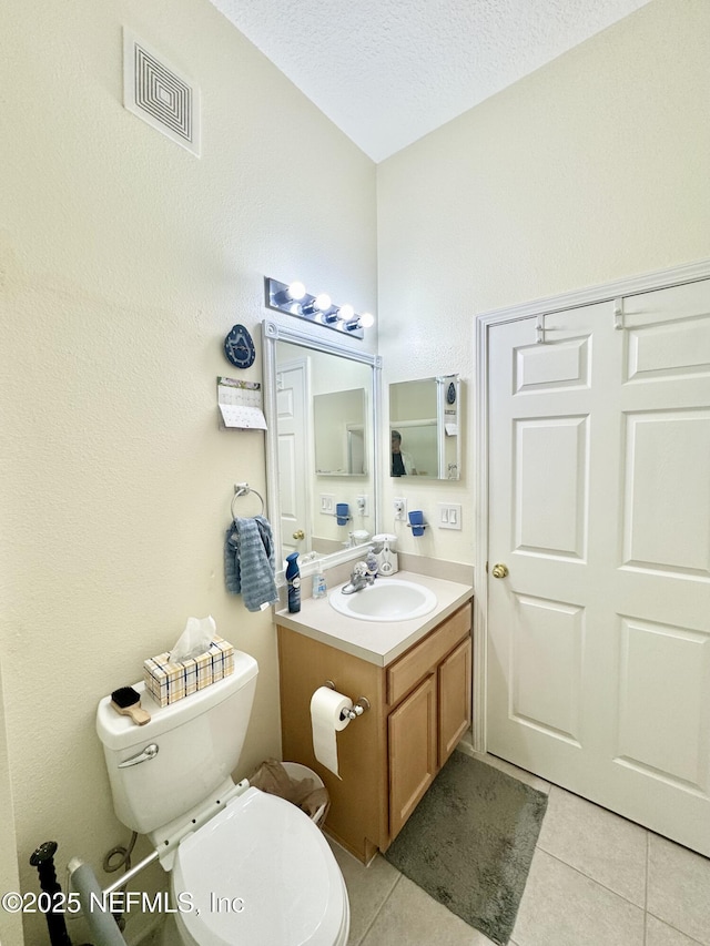 9421 Osprey Branch Trl Unit 4, Jacksonville, FL 32257 - bathroom with vanity, tile patterned floors, toilet, visible vents, and a textured ceiling