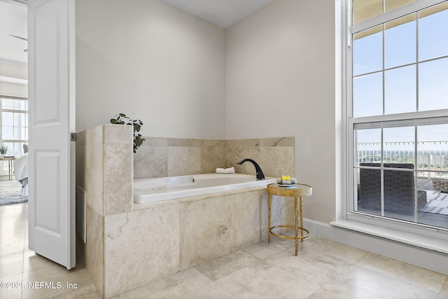 bathroom featuring tile patterned flooring and a bath