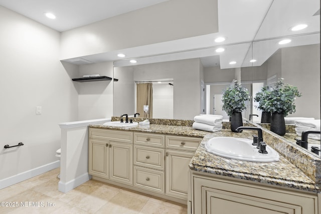 full bath with recessed lighting, a sink, and baseboards