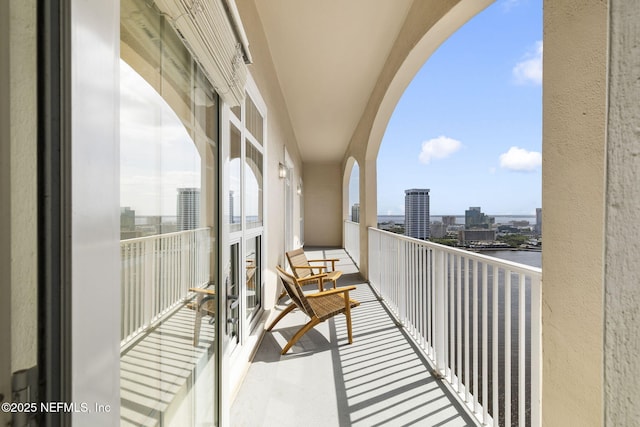 balcony with a water view and a city view