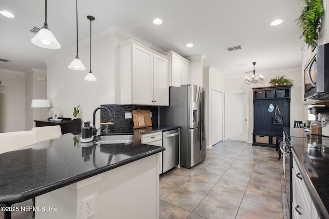 72 Whistler Trce, Ponte Vedra, FL 32081 - kitchen with a notable chandelier, appliances with stainless steel finishes, a sink, white cabinetry, and visible vents
