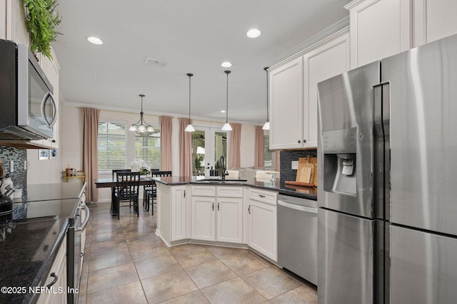 72 Whistler Trce, Ponte Vedra, FL 32081 - kitchen featuring a sink, a peninsula, backsplash, and stainless steel appliances