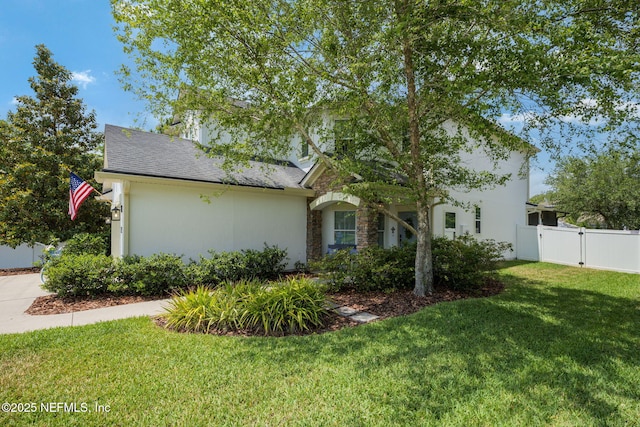 72 Whistler Trce, Ponte Vedra, FL 32081 - view of home's exterior with a lawn, fence, a gate, and stone siding