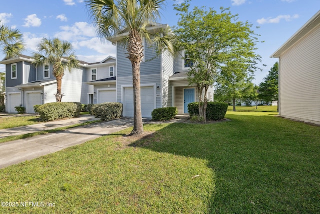view of front facade featuring a front lawn, driveway, and an attached garage