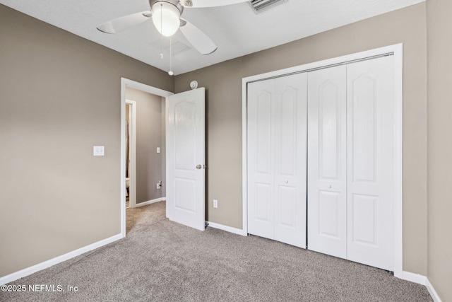 unfurnished bedroom featuring a closet, carpet, baseboards, visible vents, and a ceiling fan