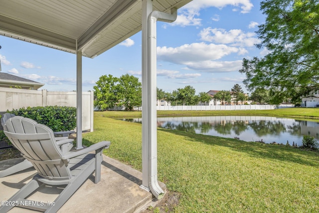 exterior space featuring a water view and fence