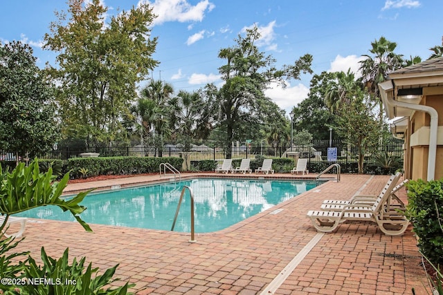 community pool featuring a patio and fence