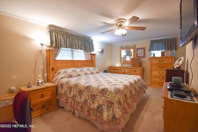 bedroom with ornamental molding, light carpet, a textured ceiling, and ceiling fan
