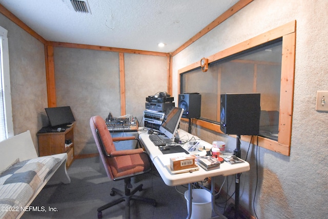 carpeted home office featuring a textured ceiling and visible vents