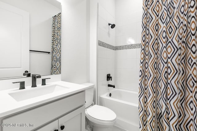 bathroom with vanity, shower / tub combo, and toilet