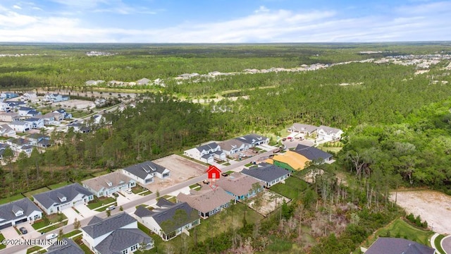 birds eye view of property featuring a view of trees and a residential view