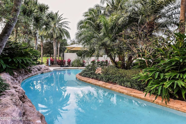 view of swimming pool with a fenced in pool