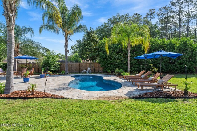 view of swimming pool with a lawn, a patio area, a fenced in pool, and a fenced backyard