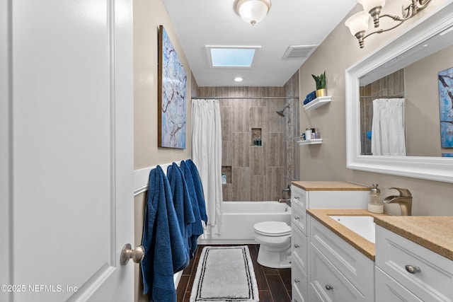 full bathroom featuring vanity, toilet, shower / tub combo, visible vents, and a skylight