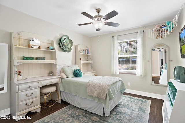 bedroom featuring baseboards, ceiling fan, and dark wood-type flooring
