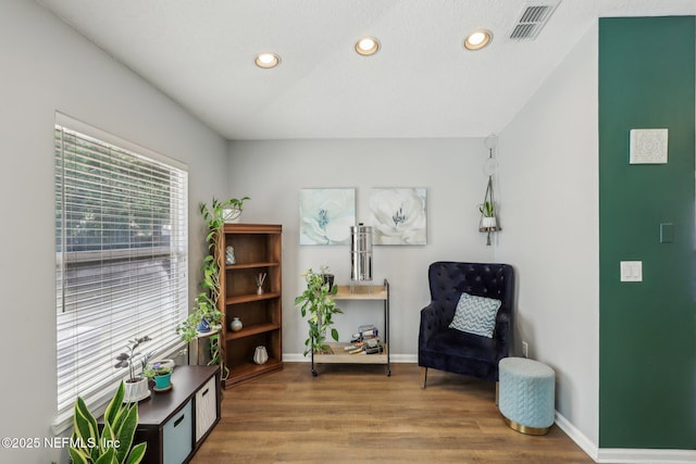 living area with recessed lighting, wood finished floors, and baseboards