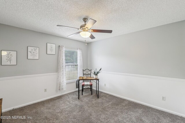 sitting room with baseboards, a ceiling fan, a textured ceiling, and carpet flooring