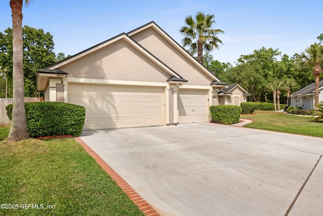 ranch-style house with a garage, stucco siding, driveway, and a front yard