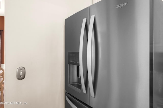 details featuring stainless steel refrigerator with ice dispenser