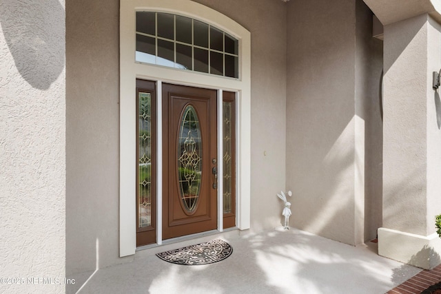 view of exterior entry with stucco siding