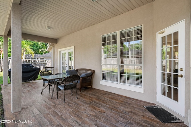 view of patio featuring a deck, french doors, outdoor dining area, and area for grilling