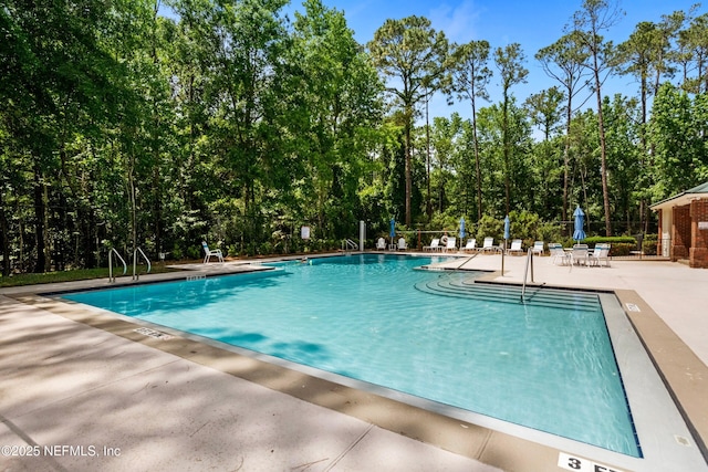 pool featuring a patio and fence