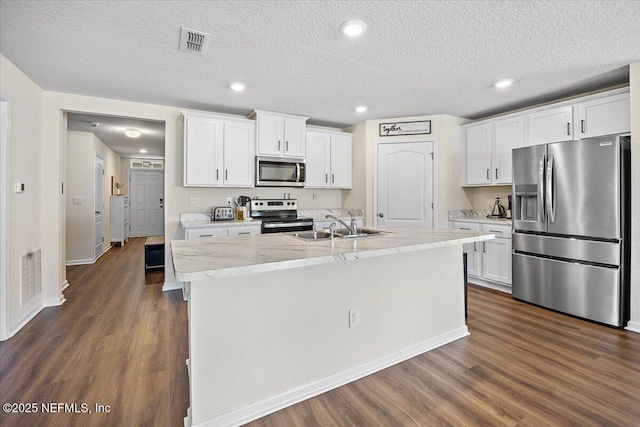 2294 Falling Star Ln, Green Cove Springs, FL 32043 - kitchen featuring stainless steel appliances, dark wood-style floors, white cabinetry, recessed lighting, and a textured ceiling