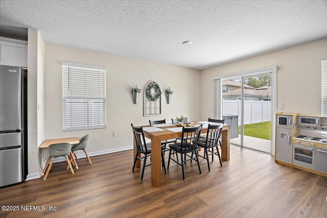 2294 Falling Star Ln, Green Cove Springs, FL 32043 - dining room featuring dark wood-style flooring and a textured ceiling