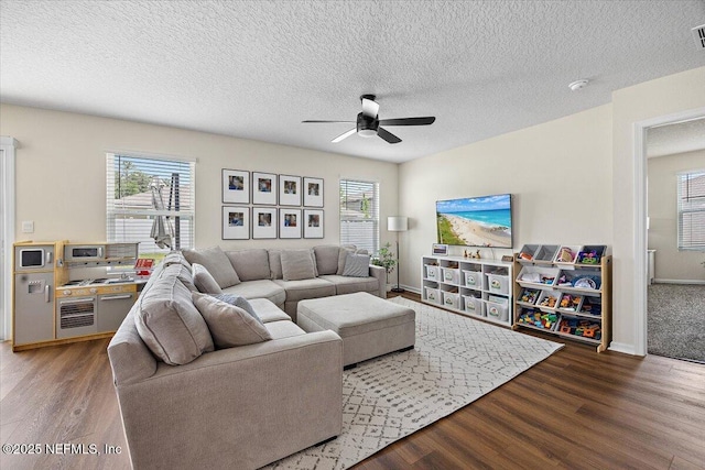 2294 Falling Star Ln, Green Cove Springs, FL 32043 - living area featuring a ceiling fan, wood finished floors, plenty of natural light, and a textured ceiling