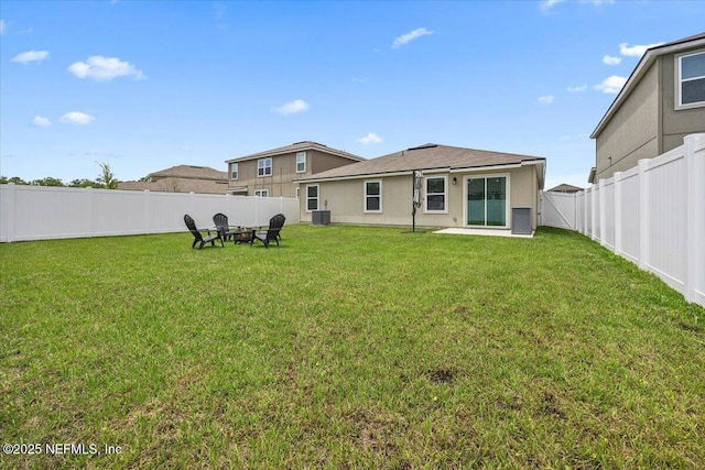 2294 Falling Star Ln, Green Cove Springs, FL 32043 - rear view of property featuring a fenced backyard, stucco siding, and a fire pit