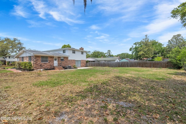 view of yard with fence, entry steps, and a patio area