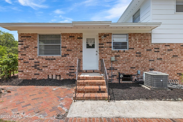 view of front of home with brick siding and cooling unit
