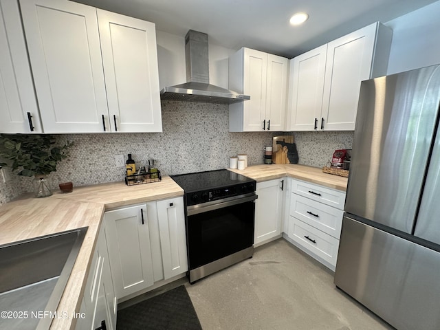 1118 Brookmont Ave E, Jacksonville, FL 32211 - kitchen with freestanding refrigerator, wall chimney exhaust hood, electric range oven, decorative backsplash, and white cabinets