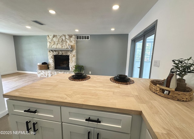 1118 Brookmont Ave E, Jacksonville, FL 32211 - kitchen featuring a fireplace, recessed lighting, butcher block countertops, and wood finished floors