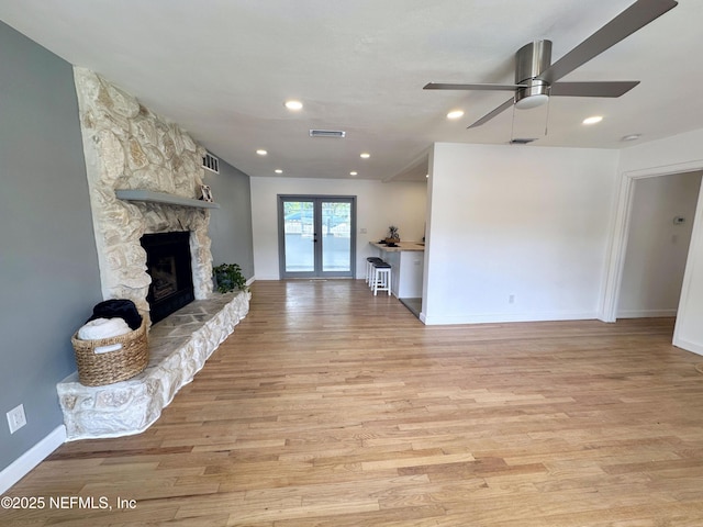 1118 Brookmont Ave E, Jacksonville, FL 32211 - unfurnished living room with a stone fireplace, ceiling fan, light wood-type flooring, french doors, and recessed lighting
