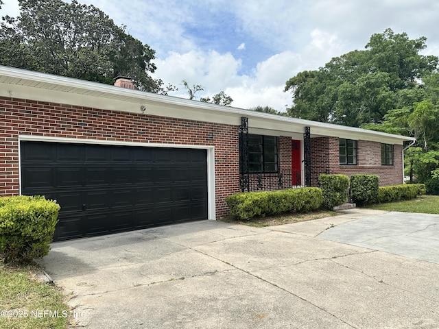1118 Brookmont Ave E, Jacksonville, FL 32211 - ranch-style home featuring concrete driveway, brick siding, and a garage