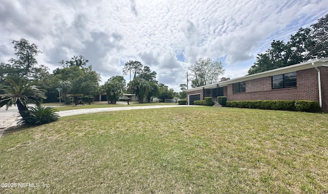 1118 Brookmont Ave E, Jacksonville, FL 32211 - view of green lawn featuring driveway and a garage