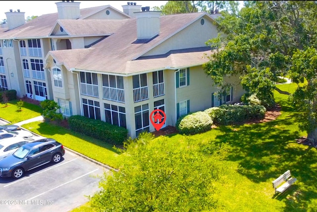 500 Sandiron Cir Unit 517, Ponte Vedra Beach, FL 32082 - view of building exterior featuring uncovered parking