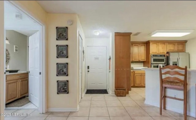 500 Sandiron Cir Unit 517, Ponte Vedra Beach, FL 32082 - kitchen with light countertops, light tile patterned floors, brown cabinets, and stainless steel appliances