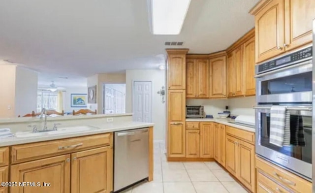 500 Sandiron Cir Unit 517, Ponte Vedra Beach, FL 32082 - kitchen featuring visible vents, light countertops, a sink, light tile patterned floors, and stainless steel appliances