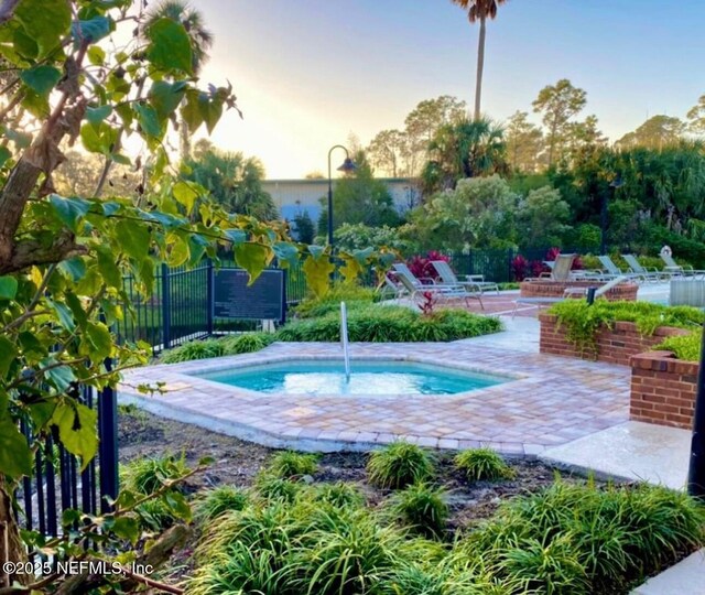 500 Sandiron Cir Unit 517, Ponte Vedra Beach, FL 32082 - pool at dusk featuring a patio and fence